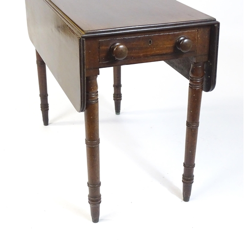 844 - A 19thC mahogany Pembroke table with two drop flaps, flanking a central short drawer and raised on t... 