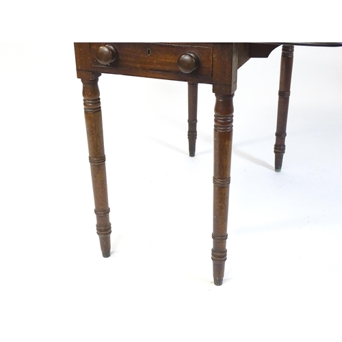 844 - A 19thC mahogany Pembroke table with two drop flaps, flanking a central short drawer and raised on t... 