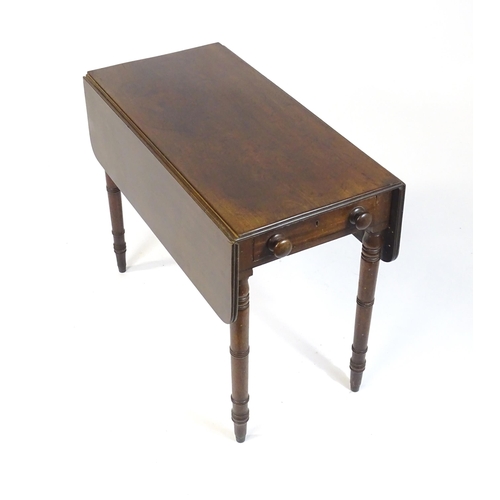 844 - A 19thC mahogany Pembroke table with two drop flaps, flanking a central short drawer and raised on t... 