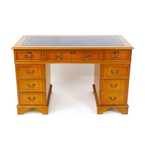 846 - A yew wood veneered double pedestal writing desk with a gold tooled inset leather top, the base comp... 