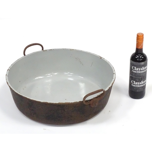 531 - Kitchenalia: a very large early 20thC cast iron pot, with two handles and enamelled finish, approx 1... 