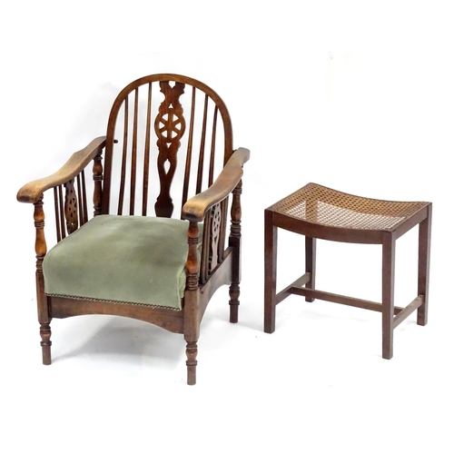 564 - A mid 20thC reclining wheelback armchair, of beech construction with upholstered seat, stamped '2157... 