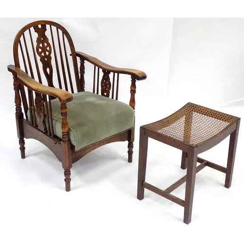 564 - A mid 20thC reclining wheelback armchair, of beech construction with upholstered seat, stamped '2157... 