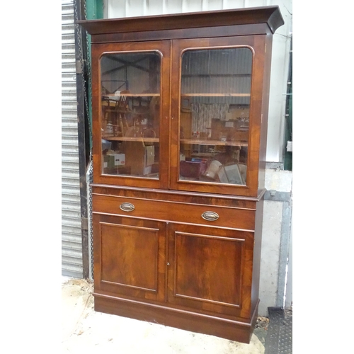 838 - A bookcase with two glazed doors enclosing three shelves, the base with single drawer and cupboard u... 