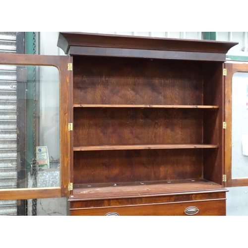 838 - A bookcase with two glazed doors enclosing three shelves, the base with single drawer and cupboard u... 