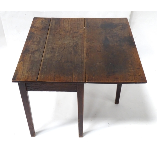 839 - A Georgian elm table with gate leg supporting a single leaf, the top approx 35