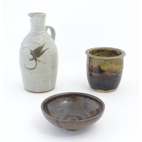 90 - Three items of studio pottery, comprising a jug with loop handle and brushwork decoration, a footed ... 