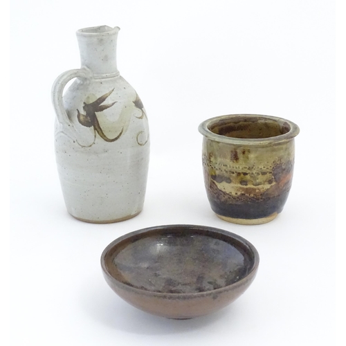 90 - Three items of studio pottery, comprising a jug with loop handle and brushwork decoration, a footed ... 