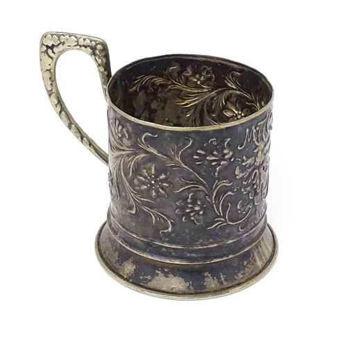 463 - A Continental white metal tisane beaker holder . With floral and foliate detail. Indistinctly marked... 