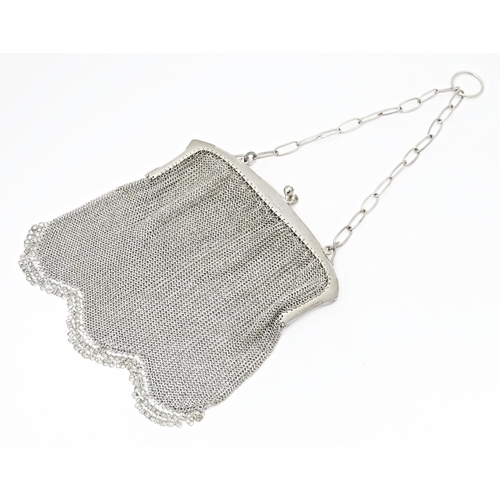 582 - An early 20thC silver bag / purse with mesh body and hanging chain, the top marked with silver impor... 