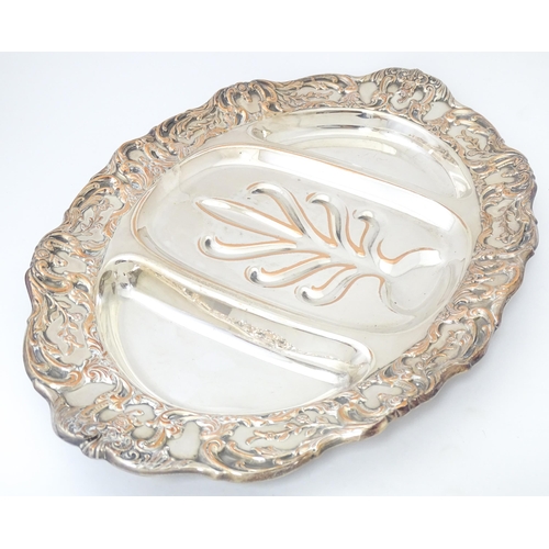 632 - A 19thC silver plate meat plate of oval form with tree and well detail to centre. Approx 17 1/2