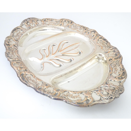 632 - A 19thC silver plate meat plate of oval form with tree and well detail to centre. Approx 17 1/2