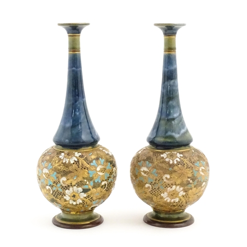 112 - A pair of Doulton Slaters Lambeth bottle vases with mottled blue glaze to neck, the body decorated w... 