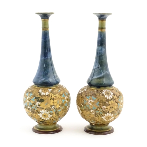 112 - A pair of Doulton Slaters Lambeth bottle vases with mottled blue glaze to neck, the body decorated w... 