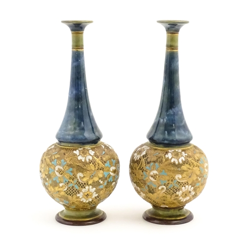 112 - A pair of Doulton Slaters Lambeth bottle vases with mottled blue glaze to neck, the body decorated w... 