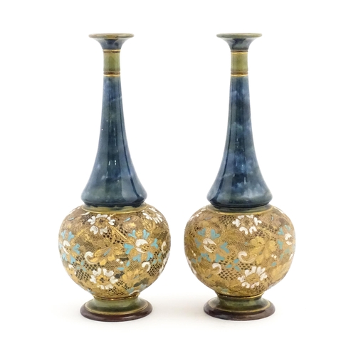 112 - A pair of Doulton Slaters Lambeth bottle vases with mottled blue glaze to neck, the body decorated w... 