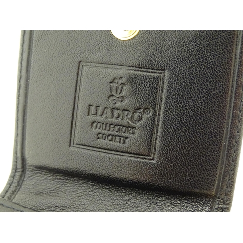 122 - A Lladro coin purse / wallet with porcelain logo. Boxed. Approx. 4