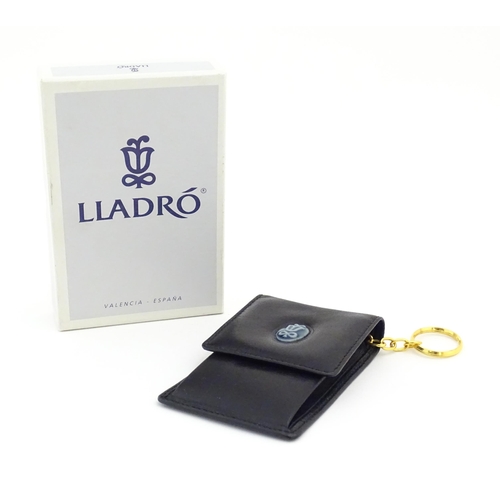 122 - A Lladro coin purse / wallet with porcelain logo. Boxed. Approx. 4