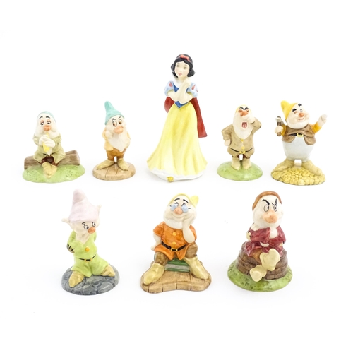 128 - Eight Royal Doulton figures / models comprising Snow White and the Seven Dwarfs, Sleepy, Bashful, Sn... 