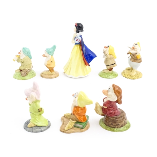 128 - Eight Royal Doulton figures / models comprising Snow White and the Seven Dwarfs, Sleepy, Bashful, Sn... 