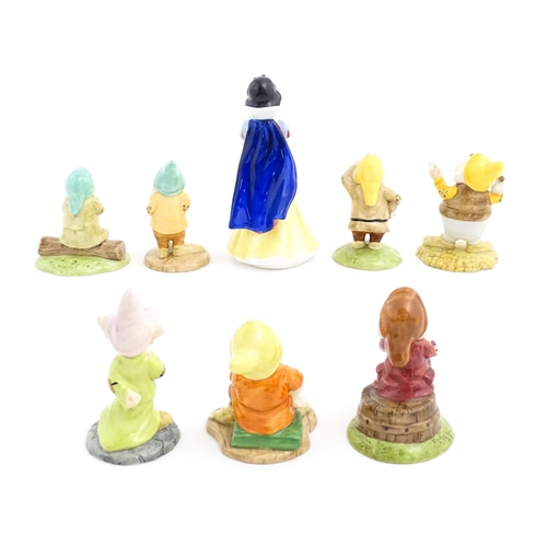 128 - Eight Royal Doulton figures / models comprising Snow White and the Seven Dwarfs, Sleepy, Bashful, Sn... 