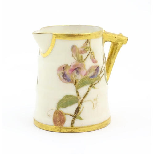 130 - A small Royal Worcester barrel shaped jug with hand painted floral and foliate decoration. Marked un... 