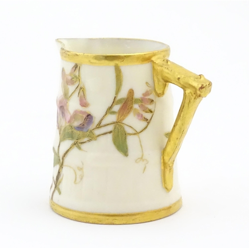 130 - A small Royal Worcester barrel shaped jug with hand painted floral and foliate decoration. Marked un... 