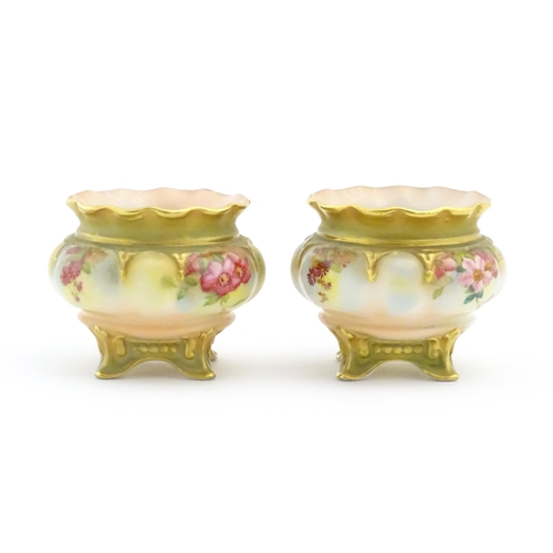 131 - Two Royal Worcester salts / pots with scalloped edge, swept feet and hand painted floral decoration.... 