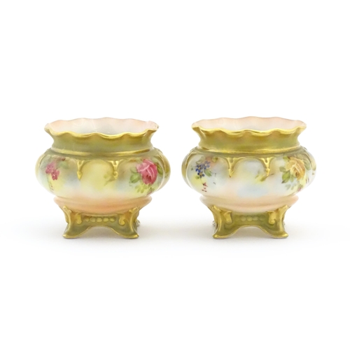 131 - Two Royal Worcester salts / pots with scalloped edge, swept feet and hand painted floral decoration.... 