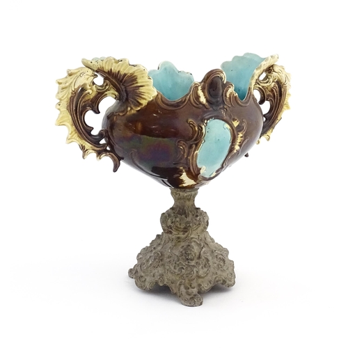 135 - A Victorian majolica centrepiece with twin handles and pedestal base. Approx. 10