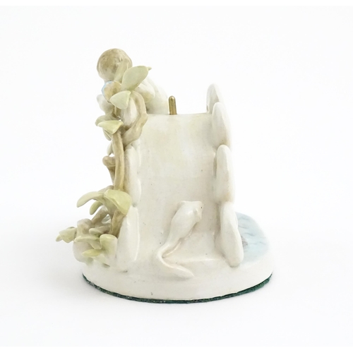 138 - A late 19th / early 20thC novelty ceramic pocket watch stand modelled as a pond with lily pads, frog... 