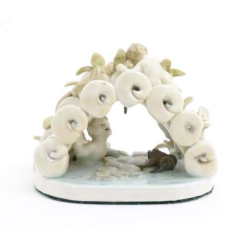 138 - A late 19th / early 20thC novelty ceramic pocket watch stand modelled as a pond with lily pads, frog... 