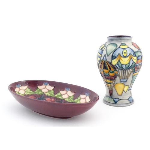 156 - Two items of Moorcroft comprising an oval dish decorated in the Morello pattern with flowers, foliag... 