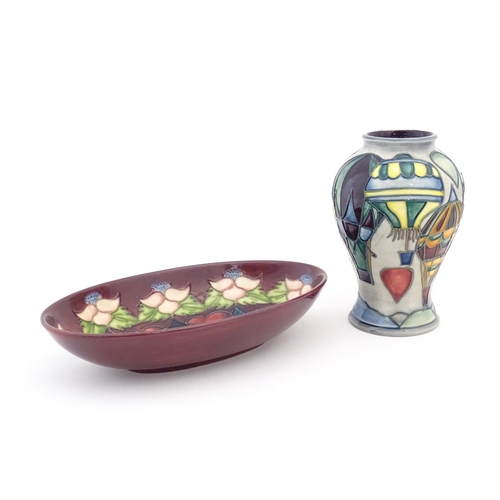 156 - Two items of Moorcroft comprising an oval dish decorated in the Morello pattern with flowers, foliag... 