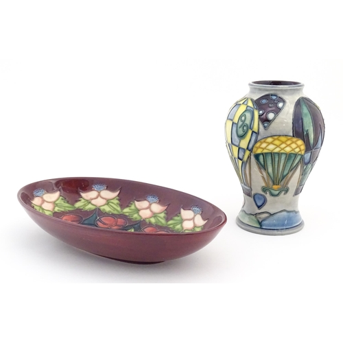 156 - Two items of Moorcroft comprising an oval dish decorated in the Morello pattern with flowers, foliag... 