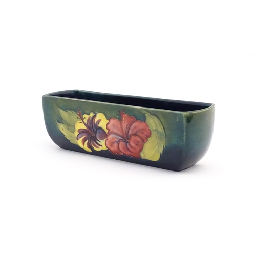 157 - A Moorcroft dish of rectangular form decorated in the Hibiscus pattern. Marked under. Approx. 2 1/2