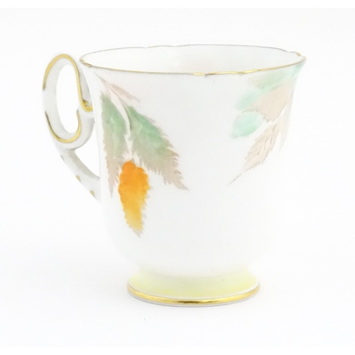 175 - An Art Deco Shelley cup and saucer decorated in the Orange Wisteria pattern. Marked under. Cup appro... 