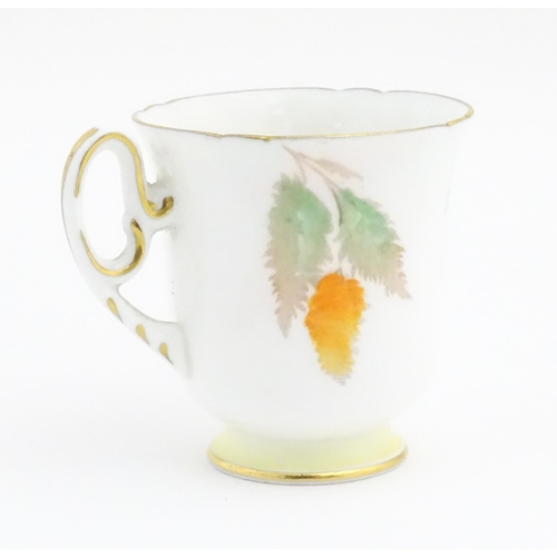 175 - An Art Deco Shelley cup and saucer decorated in the Orange Wisteria pattern. Marked under. Cup appro... 