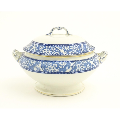 186 - A Wedgwood & Co. blue and white soup tureen and ladle with transfer decoration in
the Hawthorn patte... 