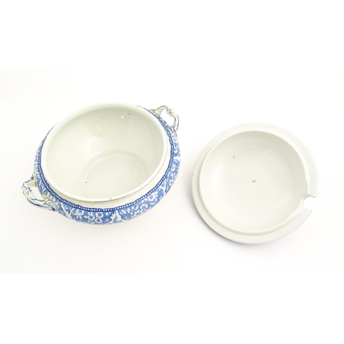 186 - A Wedgwood & Co. blue and white soup tureen and ladle with transfer decoration in
the Hawthorn patte... 