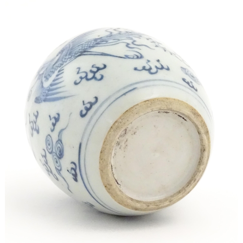 33 - A small Chinese blue and white jar decorated with phoenix birds amongst stylised clouds. Approx. 4 1... 