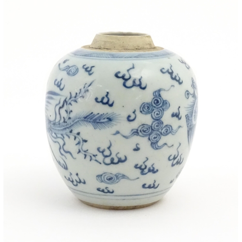 33 - A small Chinese blue and white jar decorated with phoenix birds amongst stylised clouds. Approx. 4 1... 