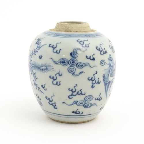 33 - A small Chinese blue and white jar decorated with phoenix birds amongst stylised clouds. Approx. 4 1... 