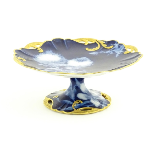 53 - A Haviland Limoges part dessert service with a blue ground and gilt highlights, decorated with Chrys... 