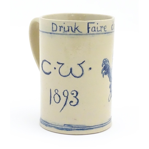 61 - A tankard with hand painted decoration depicting a rampant lion and the motto Drink Faire Dont Swear... 