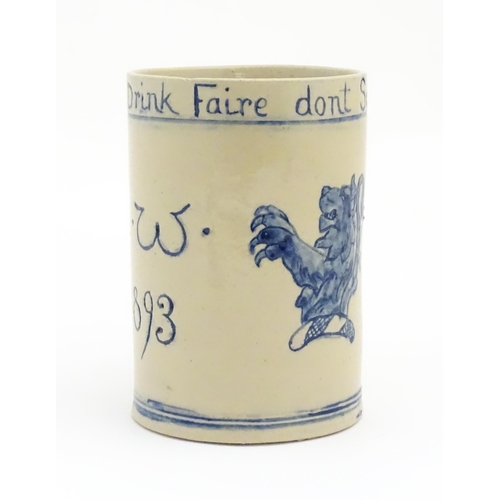 61 - A tankard with hand painted decoration depicting a rampant lion and the motto Drink Faire Dont Swear... 