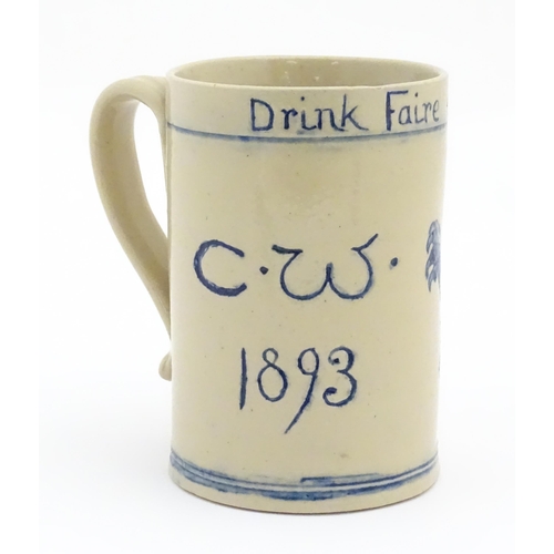 61 - A tankard with hand painted decoration depicting a rampant lion and the motto Drink Faire Dont Swear... 