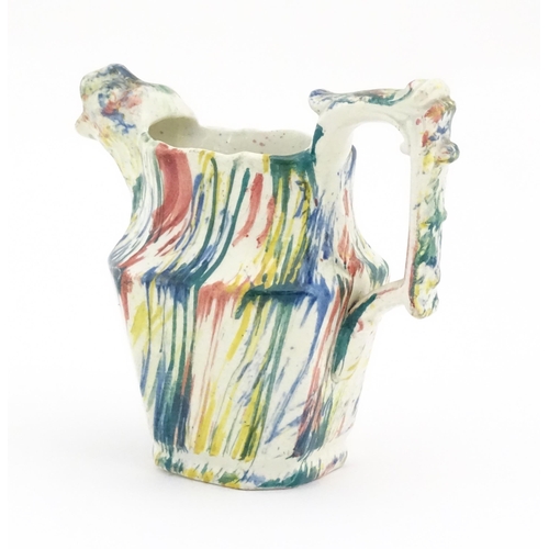 63 - A 19thC small jug with zoomorphic spout decorated in Pratt colours. Approx. 4 1/4