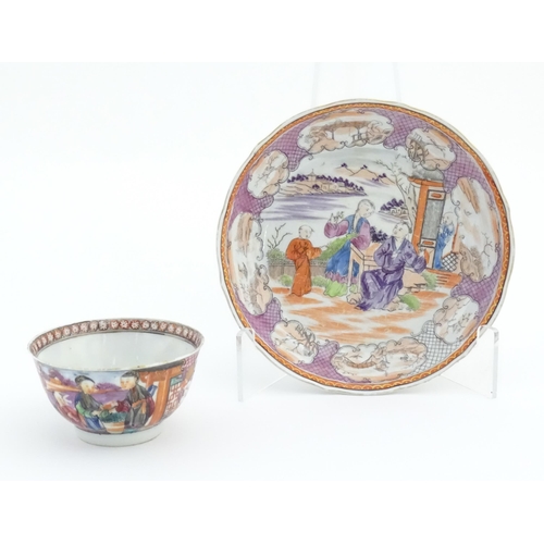 65 - A Miles Mason style tea bowl and saucer in the pattern Boy At Door, depicting Oriental figures in a ... 