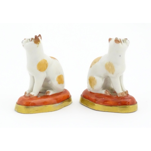 67 - A pair of porcelain models of cats in the manner of Chelsea. Marked under with gilt anchor. Approx. ... 